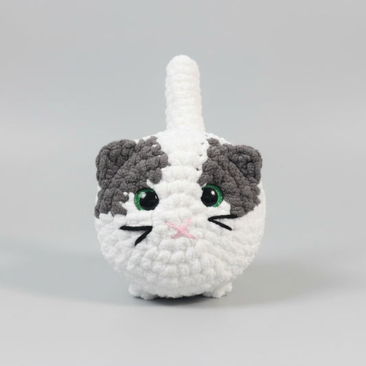 Crocheted cat toy on a wooden table with a blurred background