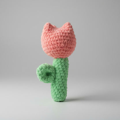 Handmade crochet Pink Tulip on a gray quilted surface