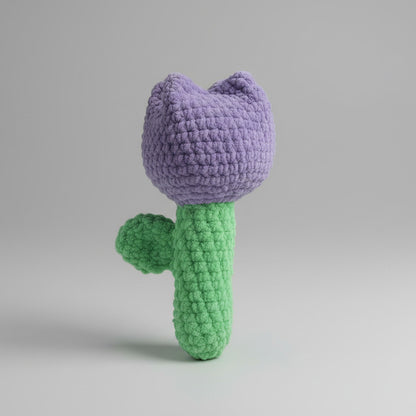 Handmade crochet Purple Tulip on a gray quilted surface