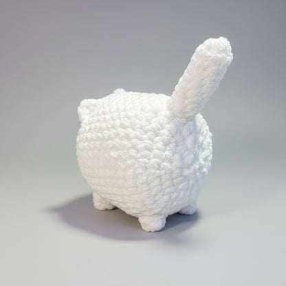 White crochet a cat on a gray background