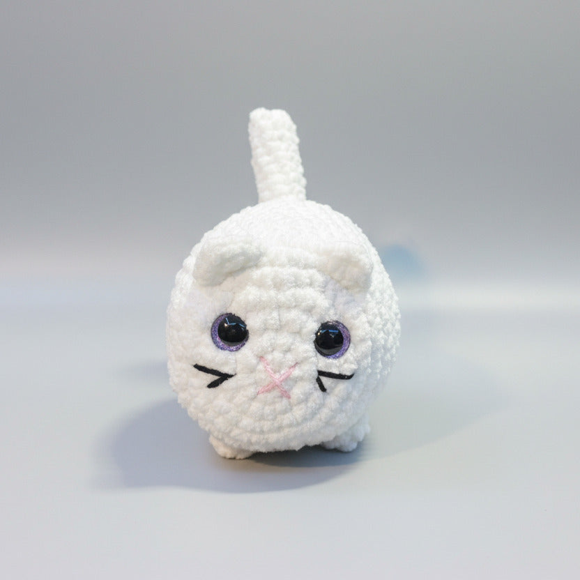 White crochet cat toy on a gray background